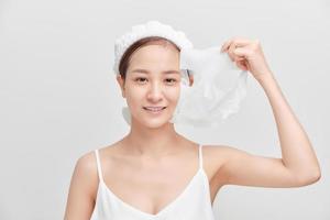 Young Asian woman removing her cosmetic mask. photo