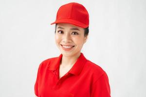 Delivery woman in red uniform isolated on white background. photo