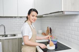 Young woman cooking in the kitchen photo