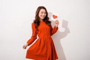 Young woman is reading Valentine card, isolated over white photo