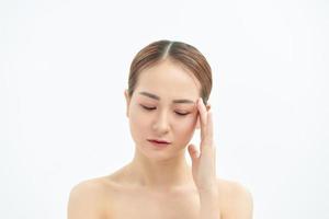 Emotional portrait of a tired and tensed young naked beautiful woman over white background. photo