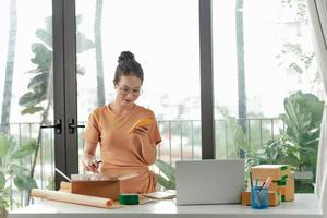 Young woman with a lot of online orders photo