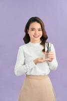 Young smiling woman holding water glass. photo