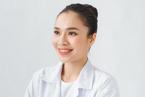 Portrait of young woman doctor with white coat standing photo