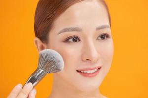 Woman making up makeup, foundation, brush photo