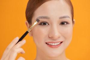 attractive woman in beauty salon make up brown eyeshadow professional photo