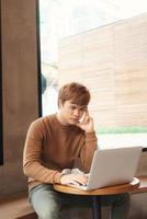 serious writer making notes about new idea working in coffee shop photo