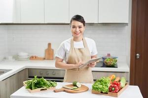 elegant housewife found new recipe for cooking in kitchen photo