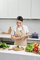 Asian housewife cooking in the kitchen photo