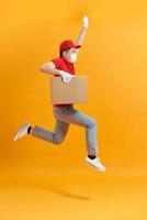 Male employee in cap t-shirt print working as courier dealer hold empty cardboard box photo