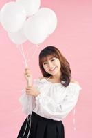 Young beautiful asian girl holding balloons. Studio. Woman holding white balloons. Birthday. photo
