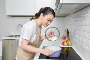 Woman cooking delicious dinner at home photo