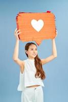 Social networking, promotion, smm concept. Young happy excited woman or girl holding a speech bubble. photo