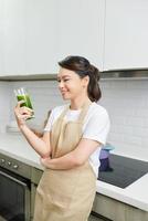 Healthy Drink. Smiling Black Girl Holding Glass, Drinking Delicious Detox Smoothie, Copyspace photo