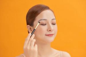 attractive woman in beauty salon make up brown eyeshadow professional photo