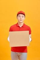 Portrait of a male delivery man holding a cargo box, background photo