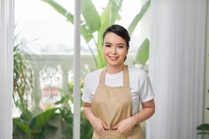 Young woman in apron at home photo