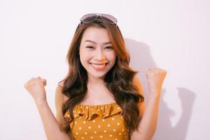 Young woman celebrating surprised and amazed for success with arms raised and open eyes photo