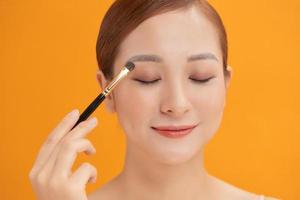 Beauty Asian Girl with Cosmetics Makeup. photo