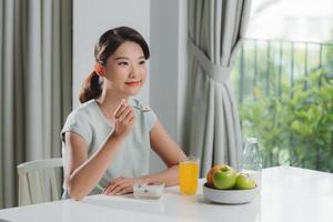 Pretty girl, happy meal eating healthy breakfast in morning, photo