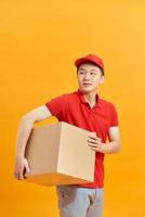 Mail man deliver package, shipping order from post man with red uniform photo