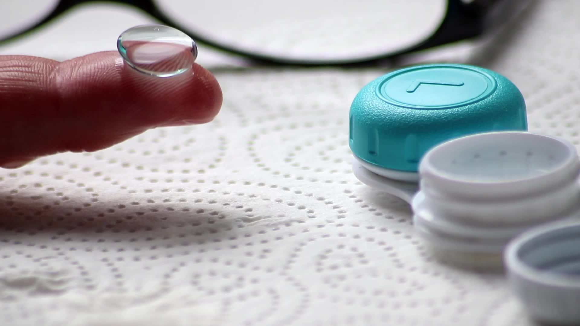 Male hands switching from eye glasses to contact lenses with hygienic