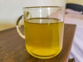 Glass or cup pot with hot ginger tea. photo