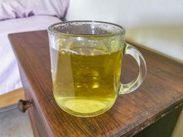 Glass or cup pot with hot ginger tea. photo