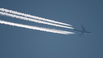 Widebody airplane flying at high altitude with contrail video