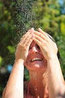 young pretty woman relaxing under shower photo