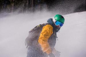 snowboarder running down the slope and ride free style photo