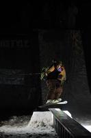 Sweden, 2022 - Freestyle snowboarder jump in air at night photo