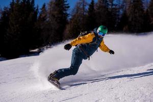 snowboarder running down the slope and ride free style photo