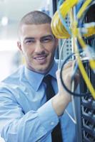 young it engeneer in datacenter server room photo