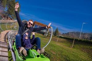 Sweden, 2022 - young father and son driving alpine coaster photo