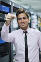 young it engineer in datacenter server room photo