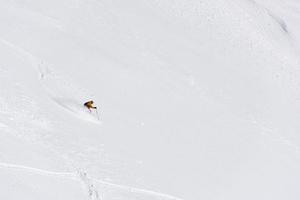 freeride skier skiing in deep powder snow photo