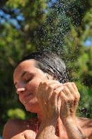 young pretty woman relaxing under shower photo