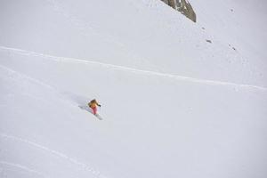 freeride skier skiing in deep powder snow photo