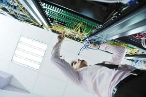 young it engeneer in datacenter server room photo