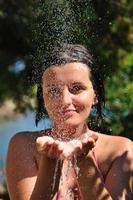 young pretty woman relaxing under shower photo