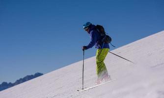 Skier having fun while running downhill photo