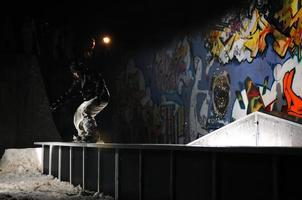 suecia, 2022 - snowboarder de estilo libre salta en el aire por la noche foto