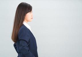 Portrait of asian businesswoman isolated on gray photo