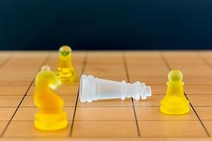 Chess glass on a wood chessboard photo