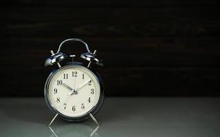 Retro alarm clock on table photo