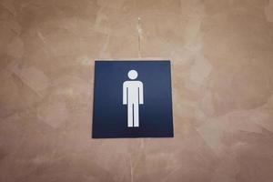 male sign in front of the toilet photo