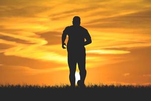 men's silhouette I am jogging to stay healthy in the evening. Men exercise by running. health care concept photo