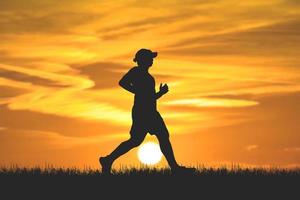 men's silhouette I am jogging to stay healthy in the evening. Men exercise by running. health care concept photo