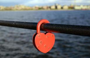 Heart shapeed lock - a symbol of love on the embankment photo